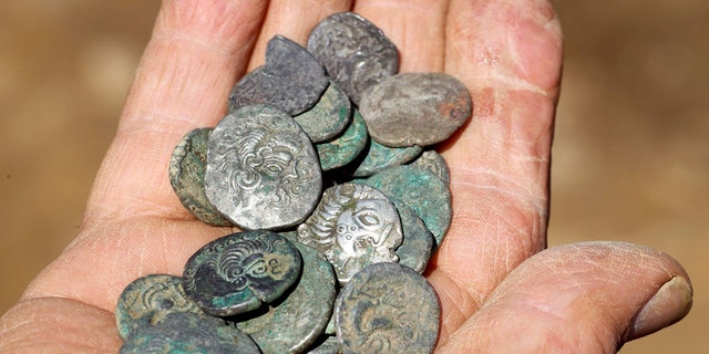 A bumper Iron Age coin hoard has been officially recognized as a Guinness World Record for the largest ever of its kind recovered in the British Isles. (Credit: SWNS)