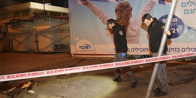 Israeli police officers inspect the scene of a ramming attack in Jerusalem on Thursday. (AP)