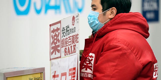 Why Japan appears to have avoided a mass coronavirus outbreak 3 A man holds a shop advertisement saying "We have masks" in Ginza shopping district Wednesday, Feb. 26, 2020, in Tokyo. At a government task force meeting Wednesday on the virus outbreak, Japan's Prime Minister Abe said he was asking organizers to cancel or postpone major sports or cultural events over the next two weeks.