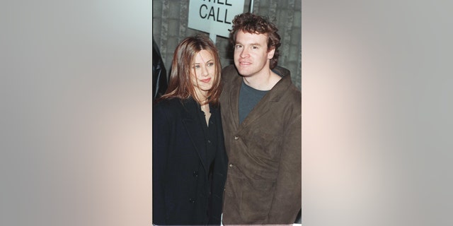 Jennifer Aniston and Tate Donovan attend a movie premiere in December 1996.