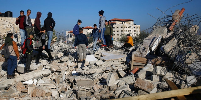 Palestinians inspect a house after it was demolished by the Israeli army in the West Bank city of Jenin on Thursday. (AP)