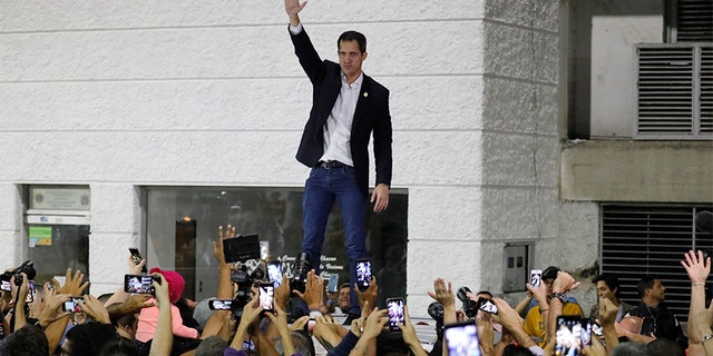 Opposition leader Juan Guaido waves to supporters during a rally at Bolivar Plaza in Chacao, a municipality of Caracas, Venezuela, on Tuesday. (AP)