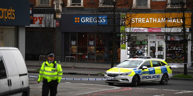 London police say officers shot a man during a "terrorism-related" incident after two people were stabbed.