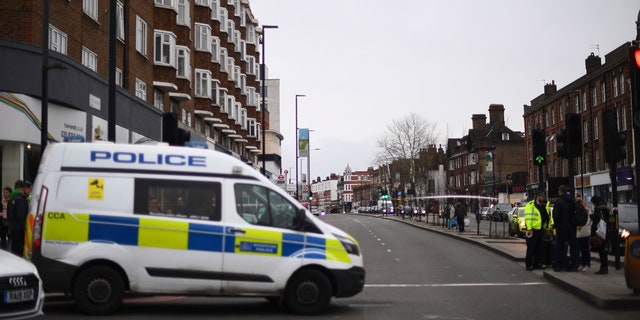 Police at the scene after an incident in Streatham, London, Sunday Feb. 2, 2020.