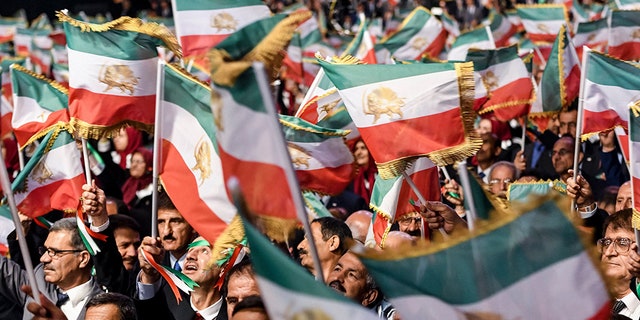 Mujahedin-e Khalq members waving Iranian flags during the conference "120 Years of Struggle for Freedom Iran" at the Ashraf-3 camp, which is a base for the People's Mojahedin Organization of Iran (PMOI, MEK) in Manza, on July 13, 2019.