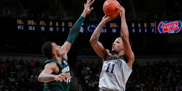 Penn State's Lamar Stevens, right, shoots against Michigan State's Xavier Tillman during the first half of an NCAA college basketball game Tuesday, Feb. 4, 2020, in East Lansing, Mich. (AP Photo/Al Goldis)