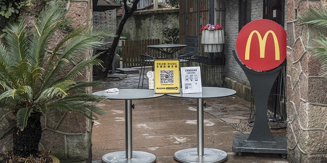 An entrance to a closed McDonald's Corp. restaurant is barricaded near the famous West Lake, usually a popular tourist attraction, in Hangzhou, China, on Tuesday, Feb. 11, 2020. The death toll from the coronavirus climbed above 1,000, as the Chinese province at the epicenter of the outbreak reported its highest number of fatalities yet. Photographer: Qilai Shen/Bloomberg via Getty Images