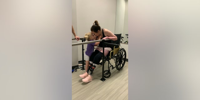 Callie Colwick kisses her daughter Kenzi.