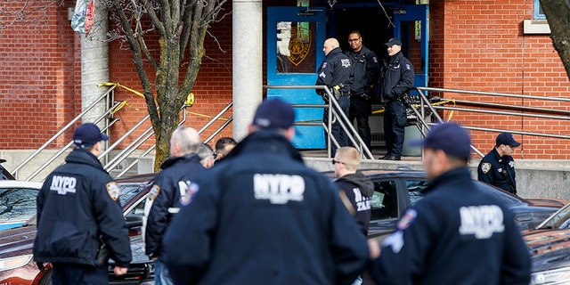 New York City police officers work the scene of a police-involved shooting outside the 41st precinct on Sunday. (AP)