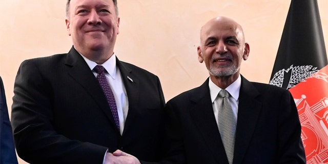 Former US Secretary of State Mike Pompeo (left) shakes hands with Afghan President Ashraf Ghani.