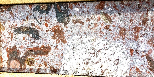 A sample of suevite rock formed nearly 15 million years ago by the Ries Crater meteorite impact. Similarly impact-generated rocks exist on the rims of ancient crater lakes on Mars. (Credit: NASA)