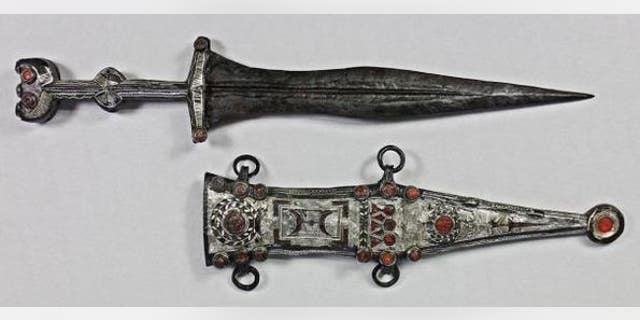 The restorer was able to remove the dagger from its sheath.