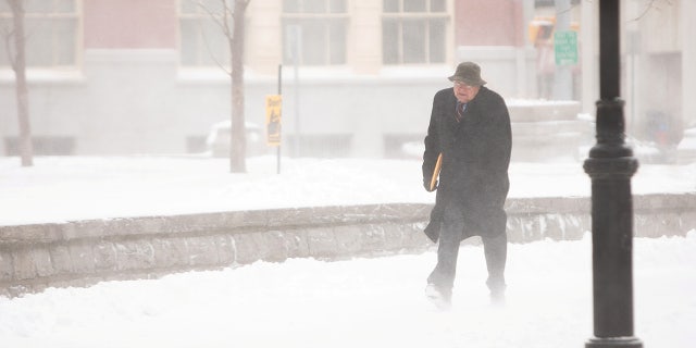 A man walks through blowing snow during blizzard in Buffalo, New York, U.S., Feb. 27. REUTERS/Lindsay DeDario