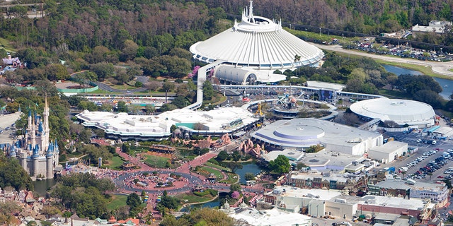 Aerial view of Walt Disney World with Cinderella's castle (left), Space Mountain & Tomorrowland (top-center), Main Street, U.S.A. (right-center) and Monorail System (right).