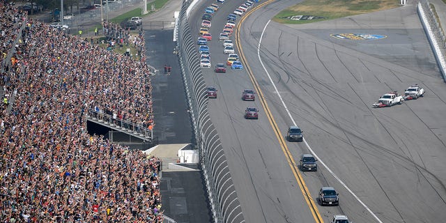 Trump's motorcade passes the grandstands as he leads the drivers around the track before the NASCAR Daytona 500 auto race at Daytona International Speedway on Sunday. (AP Photo/Phelan M. Ebenhack)