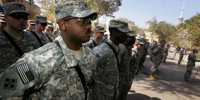 US army soliders from 4/42 Field Artillery Battalion look on during a transfer ceremony in the heavily fortified Green Zone area March 4, 2009 in Baghdad, Iraq.