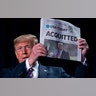 President Trump holds up a newspaper with the headline that reads "ACQUITTED" at the 68th annual National Prayer Breakfast in Washington, D.C., Feb. 6, 2020.