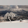 A man snowboards down a slope overlooking Mount Yotei at a ski resort in Niseko, Hokkaido, Japan, Feb. 5, 2020.?
