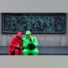 Two revelers wait at a monument for the start of the traditional alternative carnival ghost parade in Cologne, Germany, Feb. 15, 2020.?