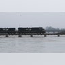 A freight train rolls over the swollen Pearl River towards Jackson, Miss., Sunday.