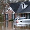 Water from the Pearl River floods this northeast Jackson, Miss., home and car Sunday. 