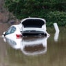 The open trunk of this vehicle is reflected in floodwaters from the Pearl River in northeast Jackson, Miss., Sunday.?