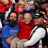 Trump supporters hold up Ervin Julian, a 100-year-old World War II veteran, during a rally supporting President Trump in Phoenix, Wednesday. 