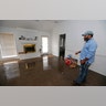 Marcus Morris inspects his girlfriend's house in Jackson, Miss., as Pearl River floodwater is reflected on the living room floor Sunday.?