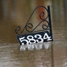 A house address sign floats as water from the Pearl River floods this Jackson, Miss., neighborhood Sunday.?