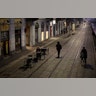 A man sits alone outside a bar at the Naviglio Grande canal in Milan, Italy, Feb. 24, 2020.