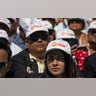 Spectators wear Trump hats as President Donald Trump and Indian Prime Minister Narendra Modi speak during a "Namaste Trump," event at Sardar Patel Gujarat Stadium in Ahmedabad, India.?