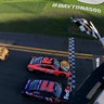 Denny Hamlin, driver of the #11 FedEx Express Toyota, takes the checkered flag ahead of Martin Truex Jr., driver of the #78 Bass Pro Shops/Tracker Boats Toyota, to win the NASCAR Sprint Cup Series DAYTONA 500 at Florida's Daytona International Speedway on Feb. 21, 2016.