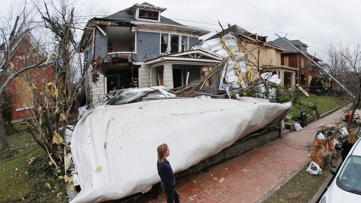 A roof from a nearby business lies in the front yard of a home Wednesday, March 4, 2020, in Nashville, Tenn. Residents and businesses faced a huge cleanup effort after tornadoes hit the state Tuesday, killing 24 people and leaving many others missing. 