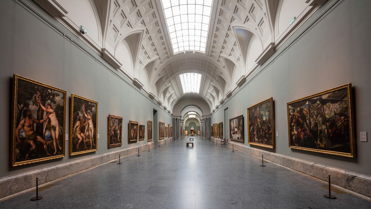 View of an empty gallery at El Prado Museum in Madrid, Spain, Thursday, March 12, 2020. The spread of the new coronavirus continues disrupting normal life in parts of Spain, and it's also affecting sports, cultural and all sorts of leisure events after the government imposed a ban on gatherings of more than 1,000 people and to cut to a third the maximum audience of all venues holding indoor sports or cultural events.  (AP Photo/Bernat Armangue)