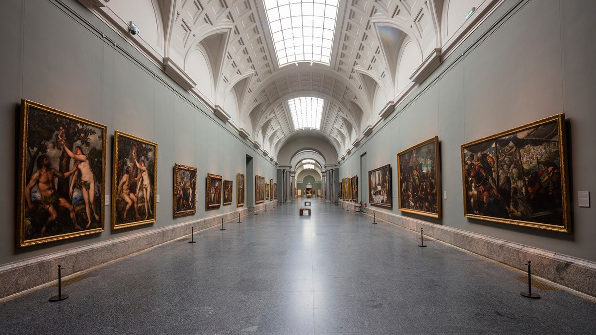 View of an empty gallery at El Prado Museum in Madrid, Spain, Thursday, March 12, 2020. The spread of the new coronavirus continues disrupting normal life in parts of Spain, and it's also affecting sports, cultural and all sorts of leisure events after the government imposed a ban on gatherings of more than 1,000 people and to cut to a third the maximum audience of all venues holding indoor sports or cultural events. (AP Photo/Bernat Armangue)