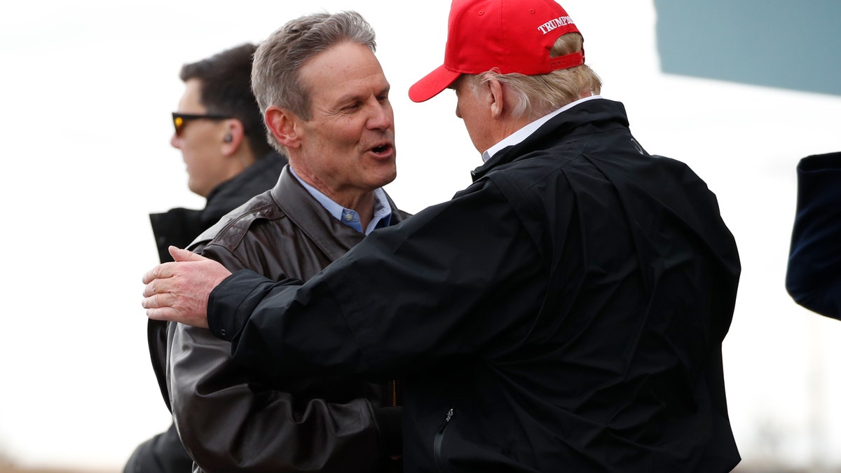 President Donald Trump speaks with Gov. Bill Lee, R-Tenn., as he arrives, Friday, March 6, 2020, at Berry Field Air National Guard Base in Nashville, Tenn. (AP Photo/Alex Brandon)
