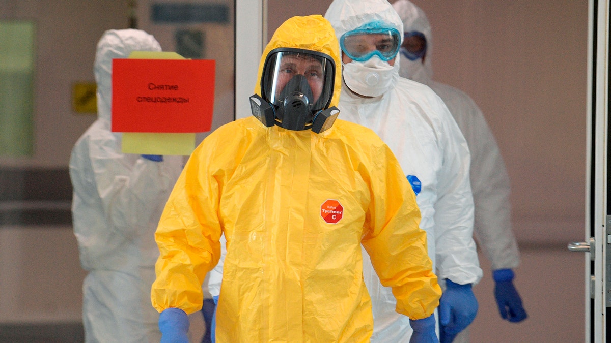 Russian President Vladimir Putin, center, wearing a protective suit as he entered a hall during his visit to a hospital for coronavirus patients in Kommunarka settlement, outside Moscow, last week. (Alexei Druzhinin, Sputnik, Kremlin Pool Photo via AP)