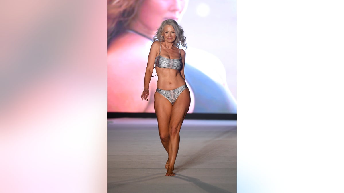 MIAMI BEACH, FLORIDA - JULY 14: Kathy Jacobs walks the runway during the 2019 Sports Illustrated Swimsuit Runway Show During Miami Swim Week At W South Beach - Runway at WET poolside lounge at W South Beach on July 14, 2019 in Miami Beach, Florida. (Photo by Frazer Harrison/Getty Images for Sports Illustrated)