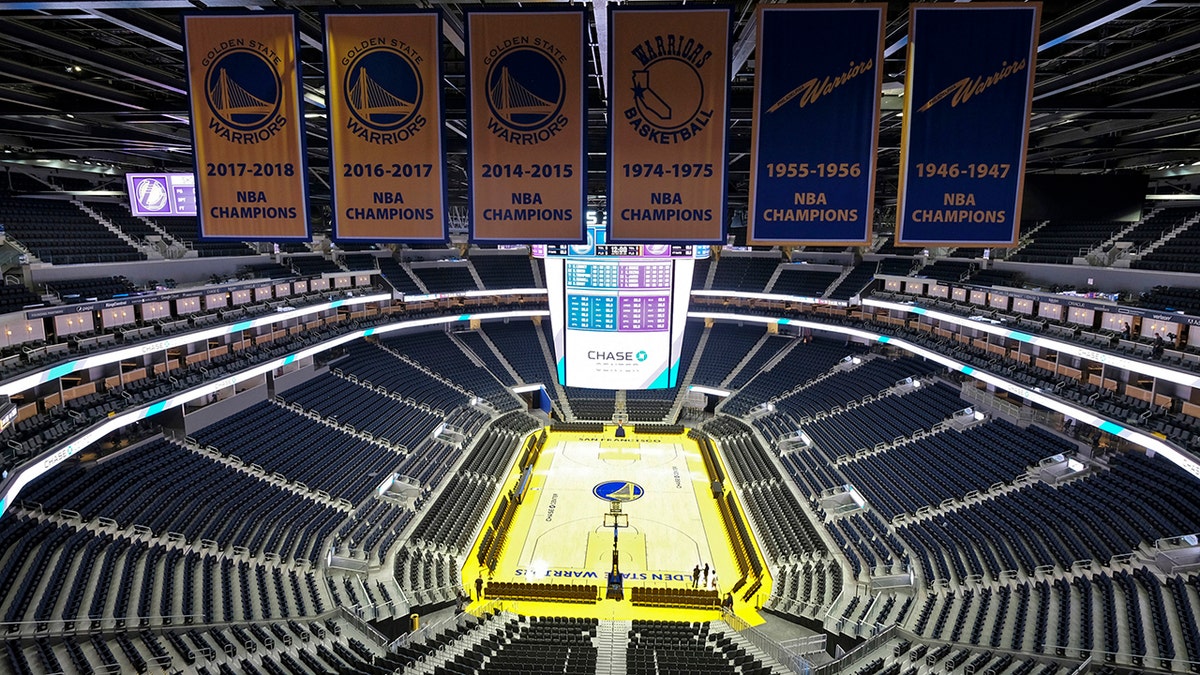 The Golden State Warriors championship banners hang above the seating and basketball court at the Chase Center in San Francisco. The NBA suspended the season Wednesday amid coronavirus fears. 