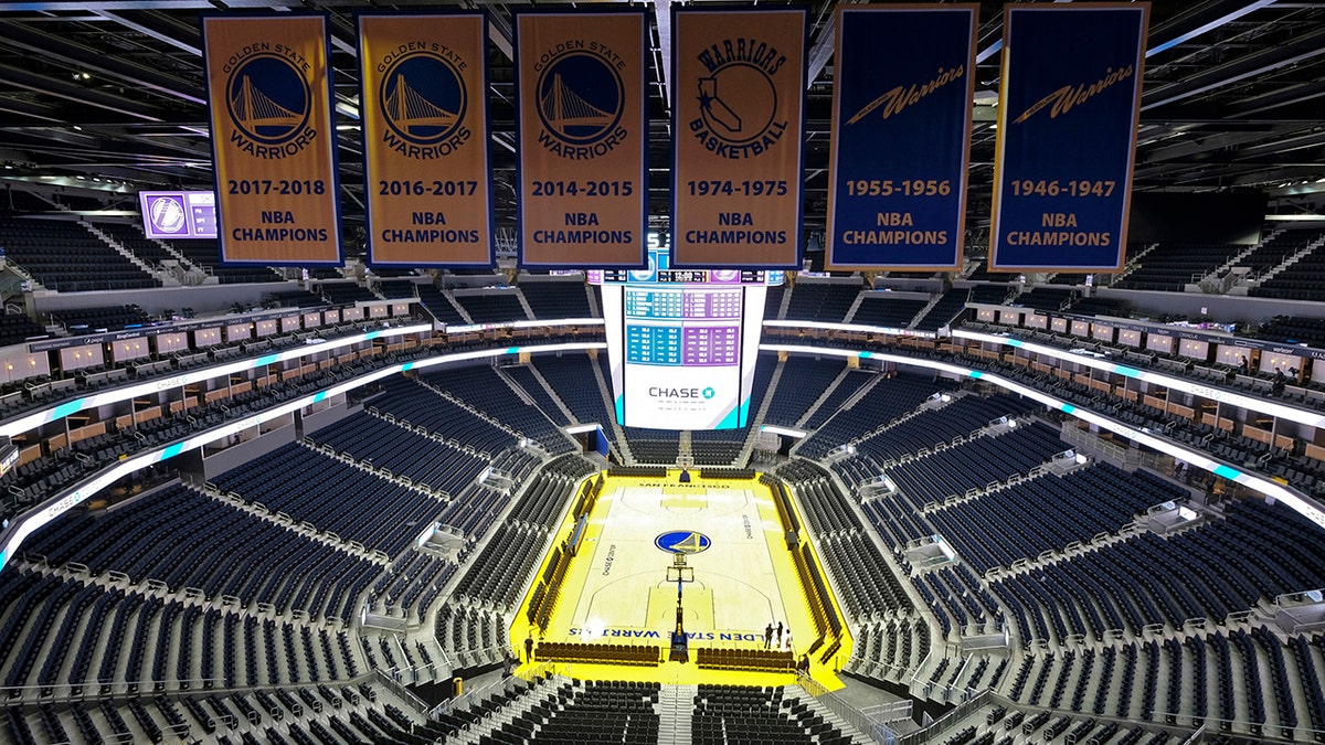 The Golden State Warriors championship banners hang above the seating and basketball court at the Chase Center in San Francisco. The NBA suspended the season Wednesday amid coronavirus fears.