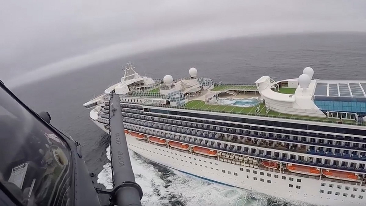 In this image from video, provided by the California National Guard, a helicopter carrying airmen with the 129th Rescue Wing flies over the Grand Princess cruise ship off the coast of California on March 5.