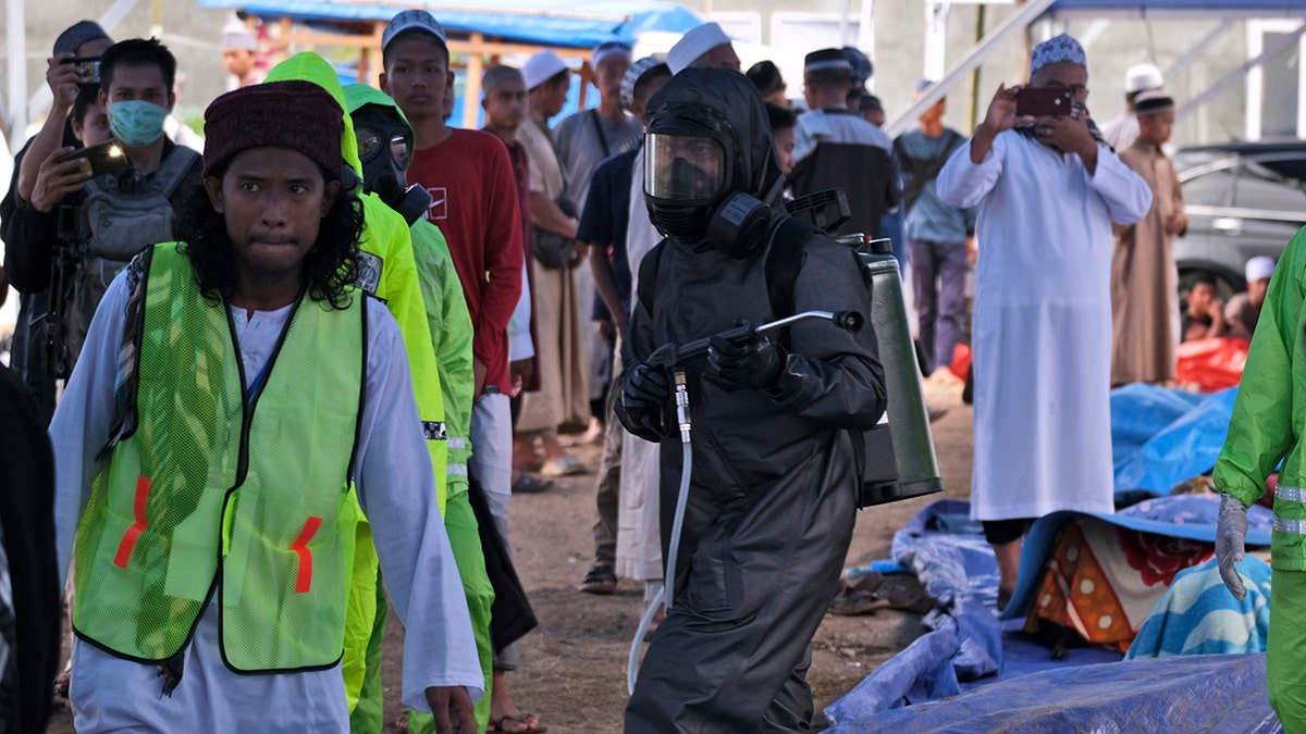 Indonesia halted the congregation of thousands of Muslim pilgrims and began quarantining and checking their health Thursday to prevent the spread of the new coronavirus. (AP)