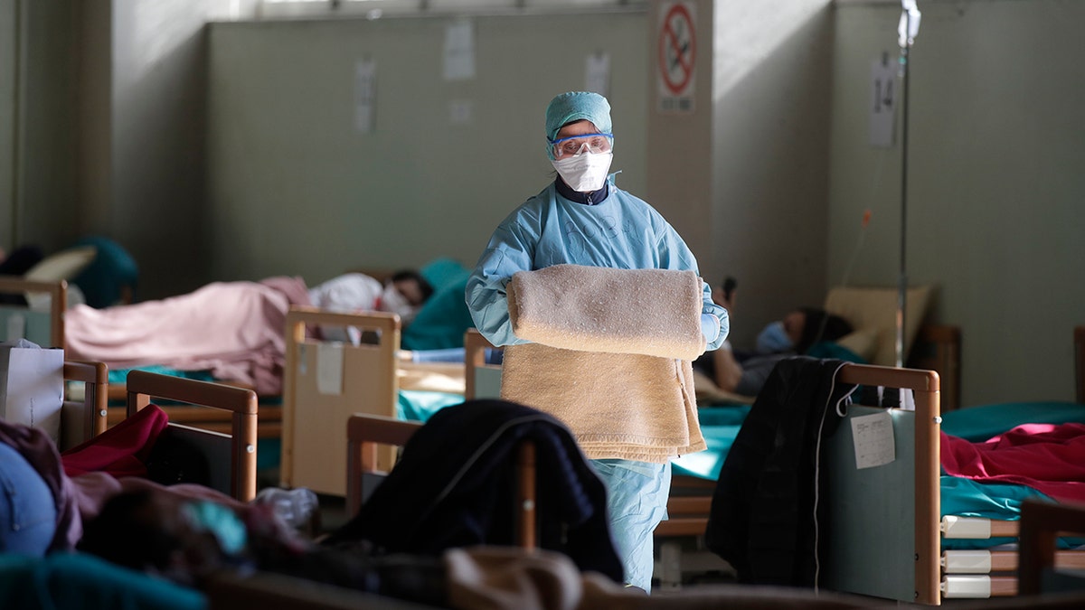 Some doctors have been forced to wear the same face mask for a 12-hour period amid shortages of medical supplies, Lodesani said. (AP Photo/Luca Bruno)
