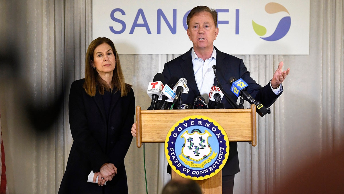 Connecticut Gov. Ned Lamont, right, speaks to the media as Lt. Gov. Susan Bysiewicz, left, looks on, during a visit to Protein Sciences, Thursday, March 12, 2020, in Meriden, Conn. The biotech company is currently researching a vaccine for COVID-19. For most people, the new coronavirus causes only mild or moderate symptoms, such as fever and cough. For some, especially older adults and people with existing health problems, it can cause more severe illness, including pneumonia. The vast majority of people recover from the new virus. 