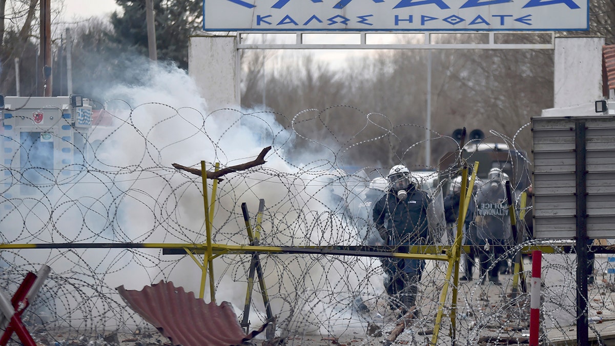 Greek border guard use teargas to push back migrants who try to enter Greece, at Pazarkule border gate, Edirne, Turkey, Saturday, Feb. 29, 2020. (Ismail Coskun/IHA via AP)