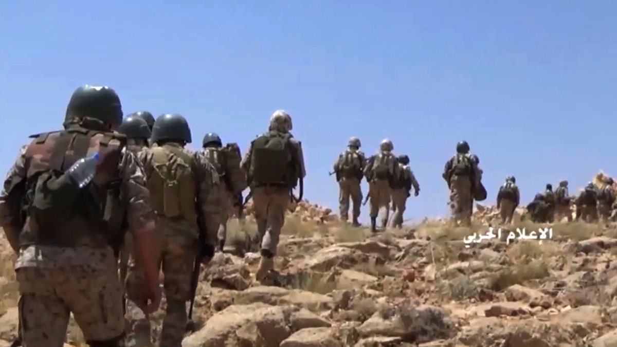 FILE - This file frame grab from video released on July 22, 2017 and provided by the government-controlled Syrian Central Military Media, shows Hezbollah fighters advancing up a hill during clashes with al-Qaida-linked militants in an area on the Lebanon-Syria border. Lebanon's militant Hezbollah group lost at least eight fighters in northwestern Syria in fighting against insurgents and airstrikes by the Turkey's air force following the death of at least 33 Turkish soldiers earlier this week, a Syrian opposition war monitor and the militant group said Saturday. (Syrian Central Military Media, via AP, File)