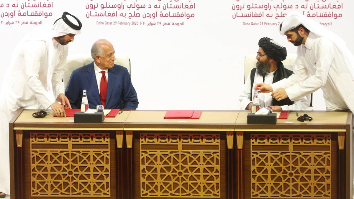 U.S. peace envoy Zalmay Khalilzad, left, and Mullah Abdul Ghani Baradar, the Taliban group's top political leader sign a peace agreement between Taliban and U.S. officials in Doha, Qatar, Saturday, Feb. 29, 2020. (AP Photo/Hussein Sayed)