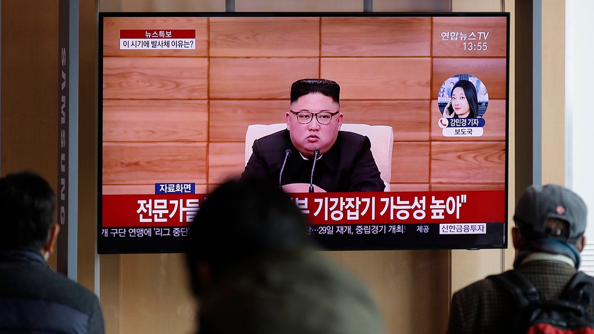 People watch a TV screen showing a news program reporting about North Korea's firing projectiles with a file footage of North Korean leader Kim Jong Un at the Seoul Railway Station in Seoul, South Korea, Monday, March 2, 2020. North Korea fired two unidentified projectiles into its eastern sea on Monday as it begins to resume weapons demonstrations after a months-long hiatus that could have been forced by the coronavirus crisis in Asia. (AP Photo/Lee Jin-man)