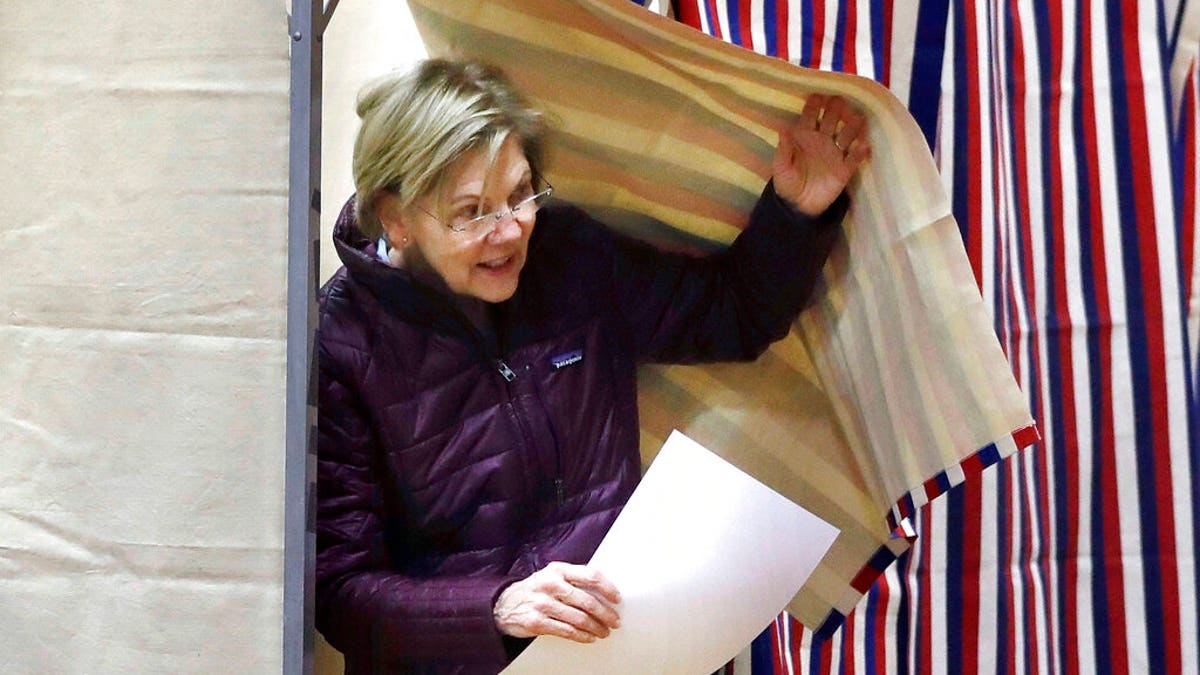 Democratic presidential candidate Sen. Elizabeth Warren, D-Mass., emerges from the booth with her ballot as she votes on Tuesday, March 3, 2020, in Cambridge, Mass. (AP Photo/Steven Senne)