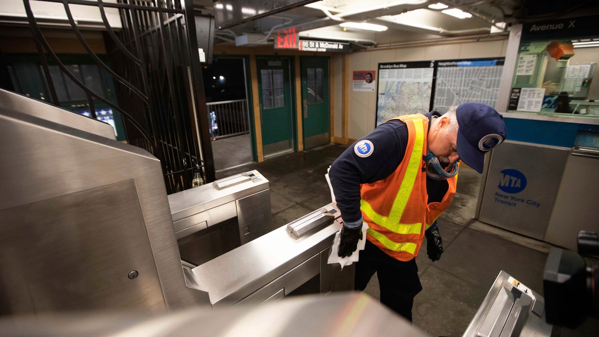 Metropolitan Transportation Authority worker Duane Clark works to sanitize surfaces at the Avenue X subway station, Tuesday, March 3, 2020, in Brooklyn. The MTA is stepping up efforts to sanitize cars and stations as fears mount over the coronavirus. (AP Photo/Kevin Hagen)